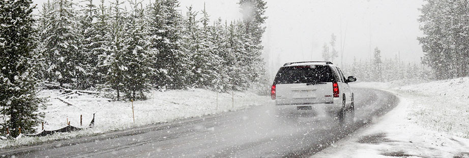 Car driving on snowy road - How to Prepare Your Car for Winter